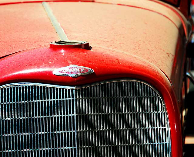 Red Lincoln in a repair lot on the northwest corner of Robertson and Charleville at the edge of Beverly Hills