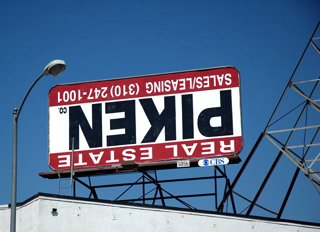 Piken Real Estate billboard upside-down on Sunset Boulevard