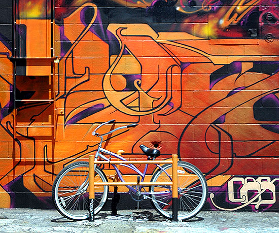 A bicycle in alley  behind a building on Melrose